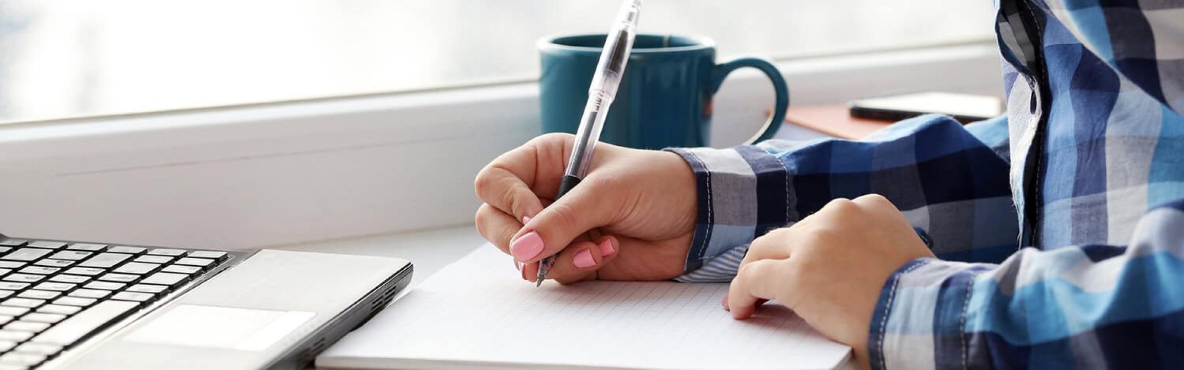 Woman with notebook and a laptop
